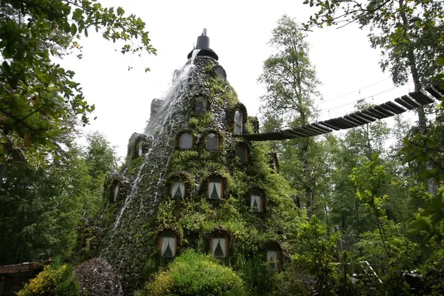 Exterior de Montaña Mágica entre árboles y un puente suspendido